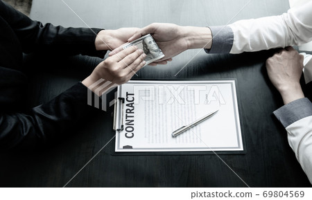 A businessman who gives money to his partner to bribe the concept of bribery and corruption 69804569