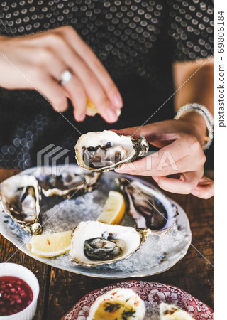 Woman squeezing lemon juice to fresh Irish 69806184