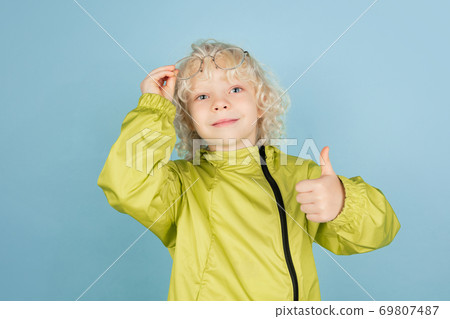 Portrait of beautiful caucasian little boy isolated on blue studio background 69807487