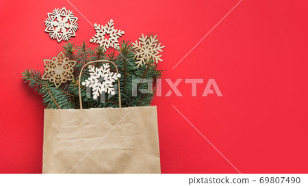 Christmas shopping bag with wooden DIY snowflakes. Christmas shopping bag with wooden DIY snowflakes. 69807490