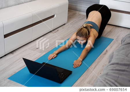 Health concept. Woman meditating or doing yoga exercise at home. 69807654
