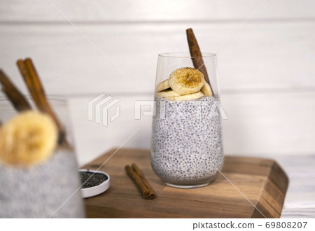 Chia seeds pudding with banana, cinnamon and yougurt on white wooden textured background Chia seeds pudding with banana, cinnamon and yougurt on white wooden textured background 69808207