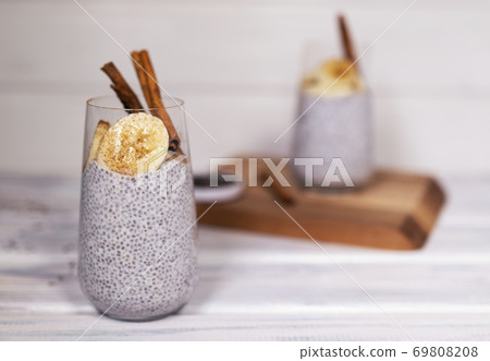 Chia seeds pudding with banana, cinnamon and yougurt on white wooden textured background 69808208