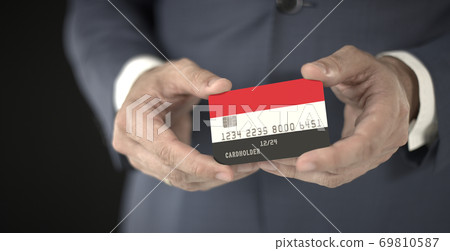 Businessman holds plastic bank card with printed flag of Yemen in his hands, fictional numbers 69810587