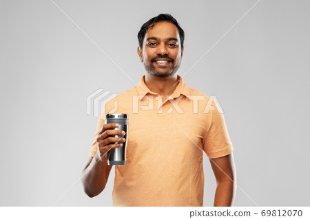 indian man with thermo cup or tumbler for drink indian man with thermo cup or tumbler for drink 69812070