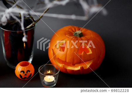 pumpkins, candles and halloween decorations 69812228
