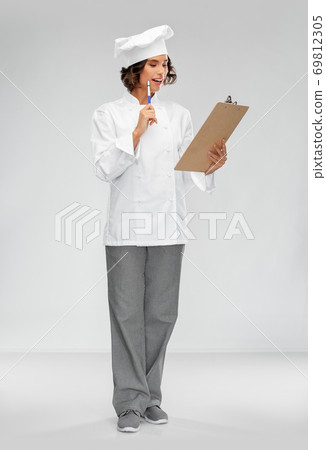 smiling female chef in toque with clipboard 69812305