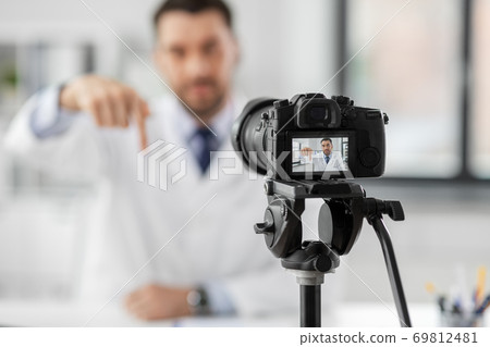 male doctor recording video blog at hospital male doctor recording video blog at hospital 69812481