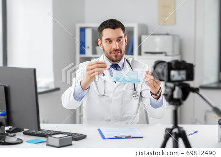 doctor with mask recording video blog at hospital doctor with mask recording video blog at hospital 69812490