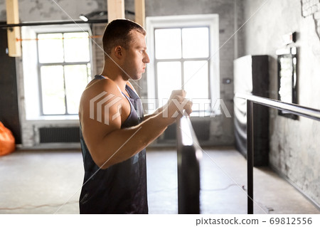 young man at parallel bars in gym young man at parallel bars in gym 69812556