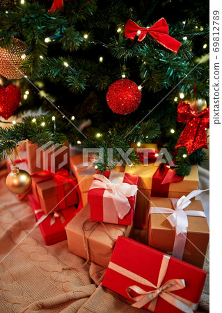 gift boxes under decorated christmas tree at home 69812789