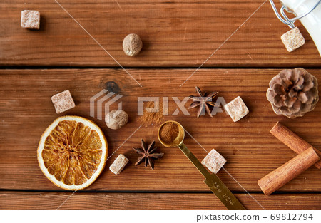spices, brown sugar and milk on wooden background spices, brown sugar and milk on wooden background 69812794