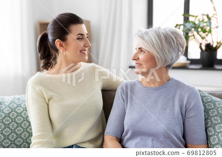 senior mother with adult daughter talking at home 69812805