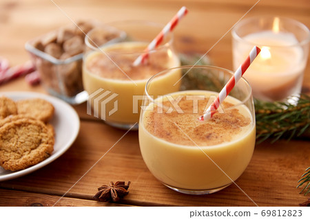 glasses of eggnog, oatmeal cookies and fir branch glasses of eggnog, oatmeal cookies and fir branch 69812823