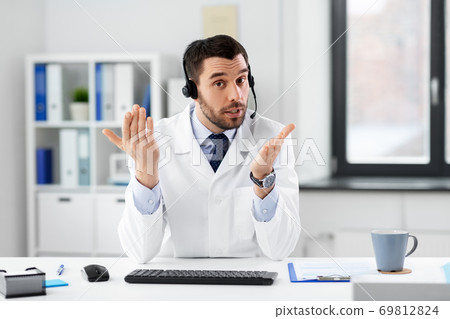 doctor with headset having video call at hospital doctor with headset having video call at hospital 69812824