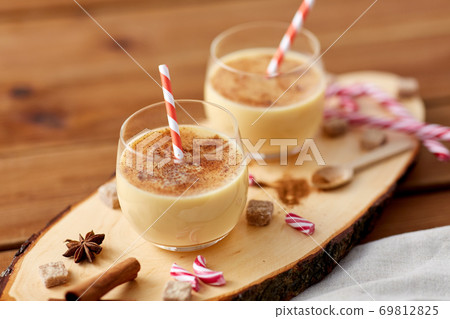 glasses of eggnog, ingredients and spices on wood glasses of eggnog, ingredients and spices on wood 69812825