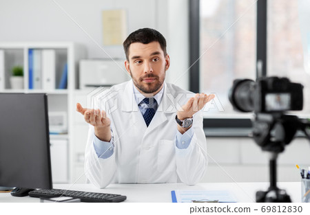 male doctor recording video blog at hospital 69812830