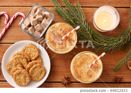 glasses of eggnog, oatmeal cookies and fir branch glasses of eggnog, oatmeal cookies and fir branch 69812831