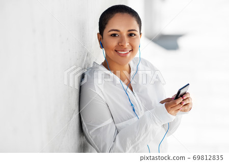 african american woman with earphones and phone african american woman with earphones and phone 69812835