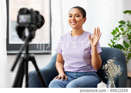 female blogger with camera video blogging at home 69812839