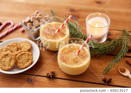 glasses of eggnog, oatmeal cookies and fir branch glasses of eggnog, oatmeal cookies and fir branch 69813017