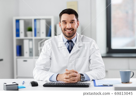 doctor in earphones having video call at clinic 69813045