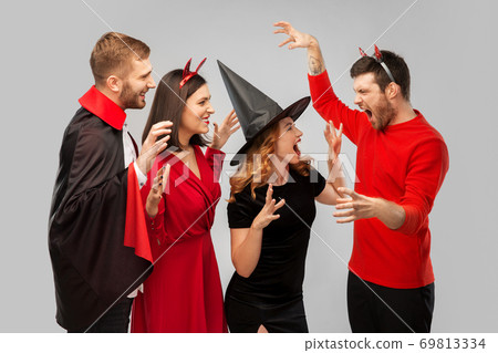 friends in halloween costumes scaring each other friends in halloween costumes scaring each other 69813334