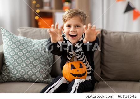 happy boy in halloween costume of skeleton at home 69813542
