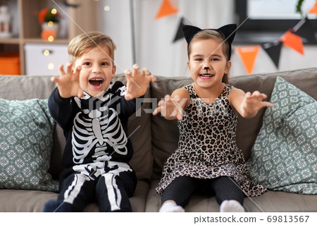 kids in halloween costumes having fun at home kids in halloween costumes having fun at home 69813567