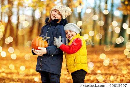 happy children with pumpkin hugging at autumn park happy children with pumpkin hugging at autumn park 69813607