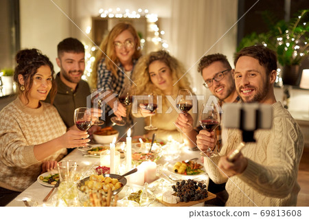 friends taking selfie at christmas dinner party friends taking selfie at christmas dinner party 69813608