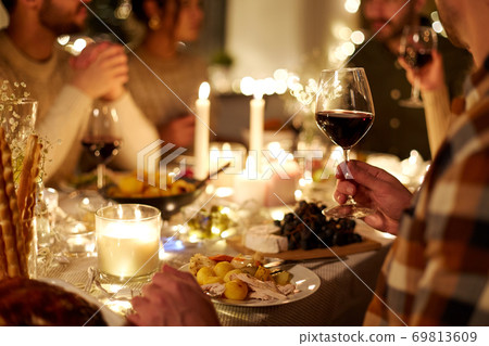 friends drinking red wine at christmas party friends drinking red wine at christmas party 69813609
