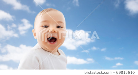 portrait of happy laughing little baby over sky 69813610