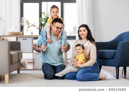 portrait of happy family sitting on floor at home portrait of happy family sitting on floor at home 69813680