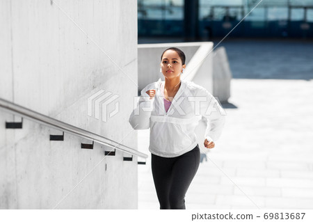 african american woman running upstairs outdoors african american woman running upstairs outdoors 69813687