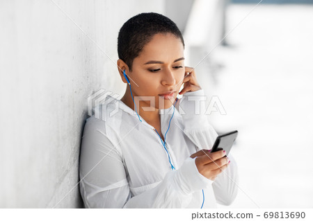 african american woman with earphones and phone african american woman with earphones and phone 69813690