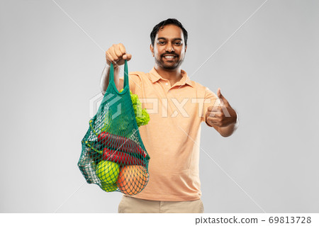 happy indian man with food in reusable net tote 69813728