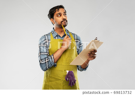 indian gardener or farmer with clipboard thinking indian gardener or farmer with clipboard thinking 69813732