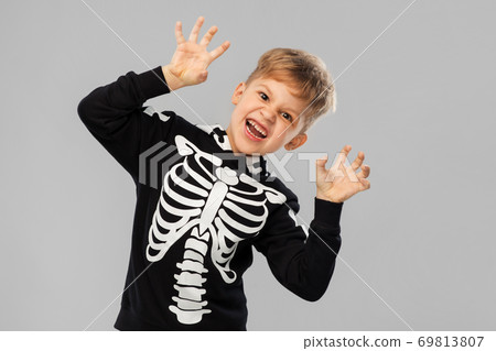 boy in halloween costume of skeleton making faces boy in halloween costume of skeleton making faces 69813807