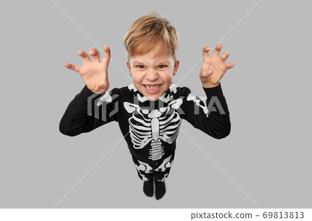 boy in halloween costume of skeleton making faces boy in halloween costume of skeleton making faces 69813813
