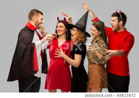 friends in halloween costumes scaring each other friends in halloween costumes scaring each other 69813872