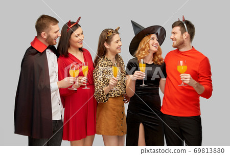 happy friends in halloween costumes over grey happy friends in halloween costumes over grey 69813880
