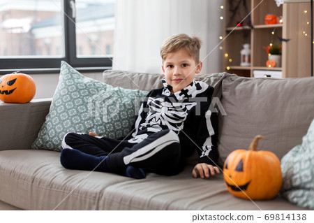 happy boy in halloween costume of skeleton at home 69814138