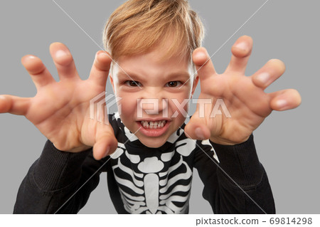 boy in halloween costume of skeleton making faces boy in halloween costume of skeleton making faces 69814298