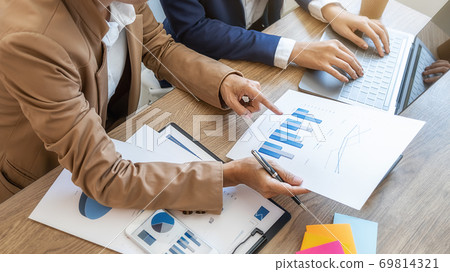 Business team brainstorming and discussing with financial data and report graph. Business team brainstorming and discussing with financial data and report graph. 69814321