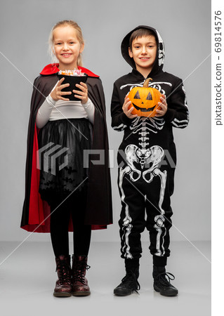 happy children in halloween costumes with candies happy children in halloween costumes with candies 69814576
