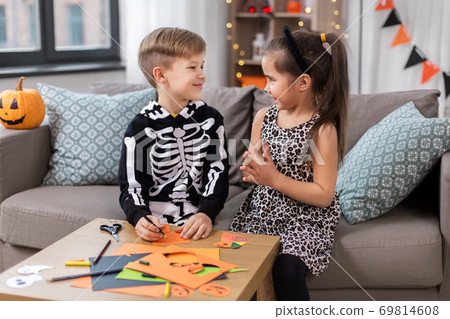 kids in halloween costumes doing crafts at home kids in halloween costumes doing crafts at home 69814608