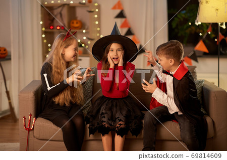 kids in halloween costumes playing at home kids in halloween costumes playing at home 69814609