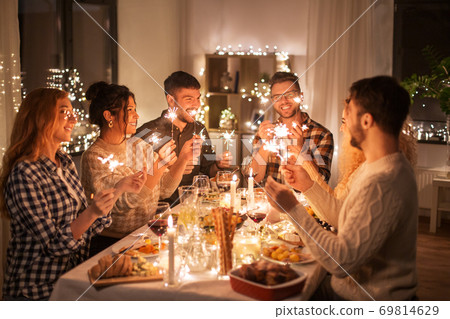 happy friends having christmas dinner at home 69814629