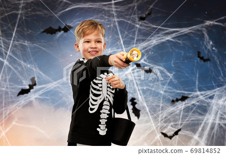 boy with candies and flashlight on halloween boy with candies and flashlight on halloween 69814852